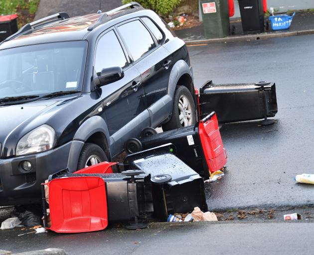 Rubbish bins awaiting emptying toppled and blew down Heriot Row, blocked in their path by a...