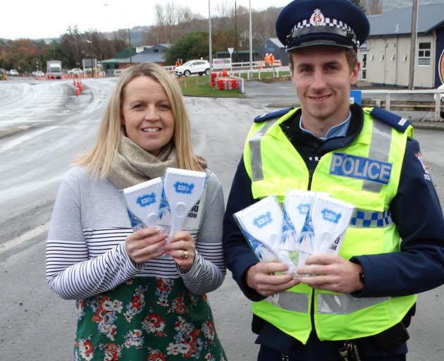 Constable Scott Turner and Greater Green Island Community Network worker Amanda Reid display some...