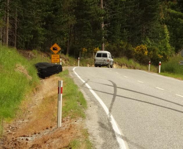 A tarpaulin covers the McLaren F1 after crashing on the Glenorchy-Queenstown Rd. Photo: Paul Taylor