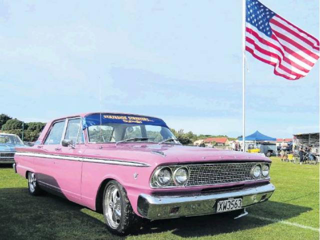 Pretty in pink . . . A 1963 Ford Fairlane, complete with American flag, on display at a previous...