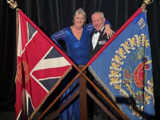 Former Ashburton resident Bruce Blackburn and wife Denise with the Battalion Colours. Photo:...