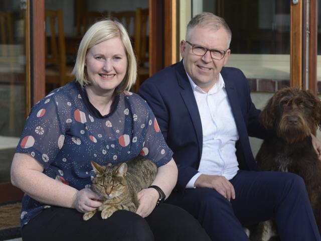 Angela and Mark Miller with their cat, Molly, and dog, Lola. PHOTO: GERARD O'BRIEN