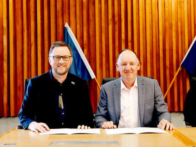 Mayor Sam Broughton and KiwiRail future state freight general manager Mark Heissenbuttel signing...