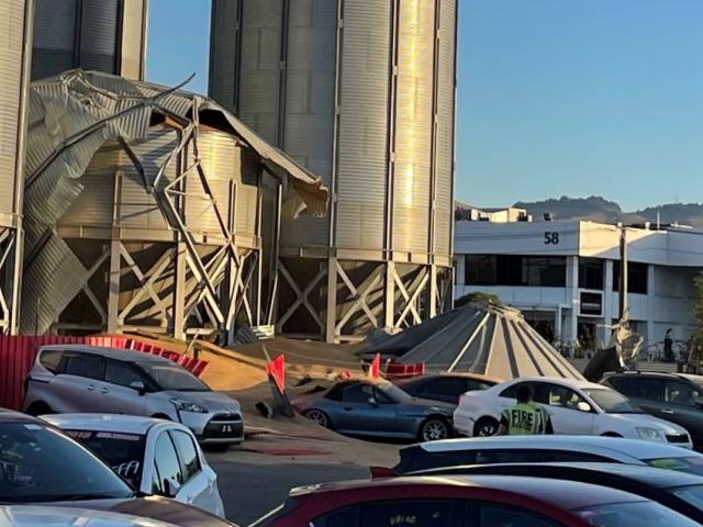 A grain silo at Champion Flour Mill in Christchurch collapsed onto a neighbouring car yard on...