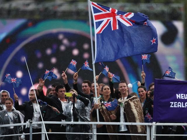 Flagbearers Jo Aleh and Aaron Murray Gate with the New Zealand team on the River Seine during the...