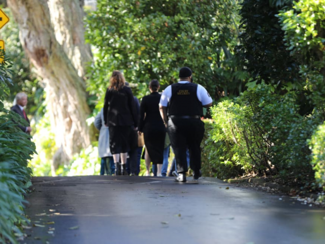 The jury entering the property from a side entrance. Photo: RNZ