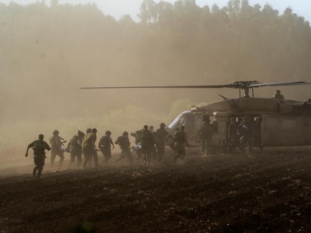 Israel's military evacuate injured people by helicopter after an anti-tank missile was fired into...