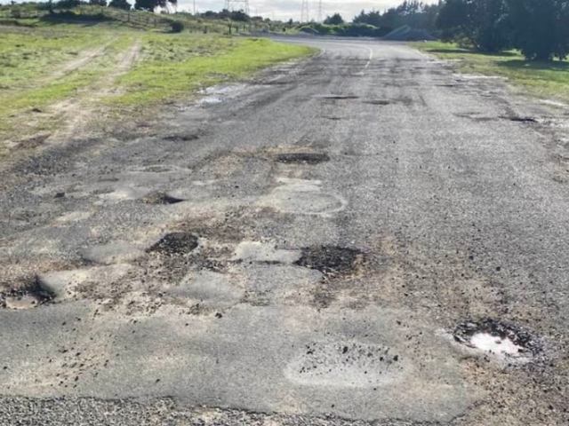 Potholes blight New Zealand's local roads, such as this one in Northland. Photo: Facebook...