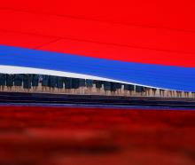 Participants hold a large-size Russian state flag during celebrations of National Flag Day, in...