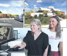 Melissa (left) and Della-May Vining look over concept plans for the Southland Charity Hospital....