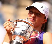 Iga Swiatek celebrates with the trophy after her victory in the French Open final. Photo: Reuters
