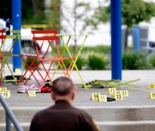 Evidence markers indicate the position of spent shell casings following a mass shooting at the...