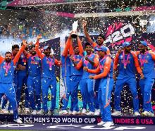 India's Kuldeep Yadav lifts the trophy as the team celebrate their victory. Photo: Reuters