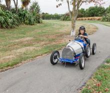 Five-year-old Benji Muckle of Ashburton takes the replica Bugatti pedal car for a spin ahead of...