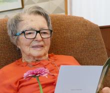 Phyllis Beeby reads one of many cards from well-wishers during her 100th birthday celebration...