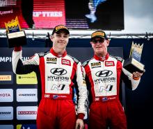 Hayden Paddon (left) and John Kennard celebrate third place at the Royal Rally of Scandinavia....