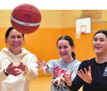 Jodi Brown has been playing club basketball with her daughters, Aria, 13 (left), and Kiana, 15....