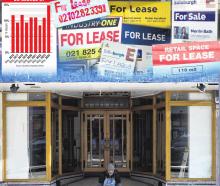 A man sits in front of an empty shop in George St. The number of vacant stores along the central...