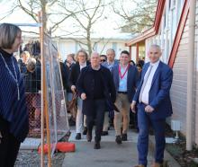 Prime Minister Christopher Luxon (centre) ran the gauntlet of excited teenagers on his walk-about...