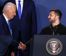 Ukraine's President Volodymyr Zelenskiy and US President Joe Biden shake hands at NATO's 75th...