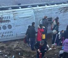 Tourist passengers by one of the buses that crashed on State Highway 8 last week. Photo: Supplied