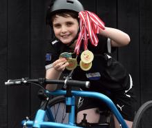 Dunedin frame runner Cooper McLennan,10, holds his collection of gold medals won competing in the...