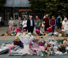 Floral tributes are laid in Southport following a vigil for the victims of the knife attack....