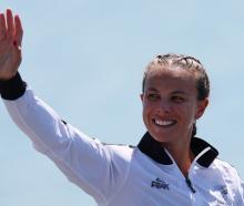 Lisa Carrington celebrates on the podium after her victory. Photo: Reuters