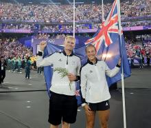 Finn Butcher and Dame Lisa Carrington fly the flag for the New Zealand team in Stade de France at...