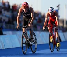 Hayden Wilde of Team NZ leads Max Studer of Team Switzerland during the triathlon mixed relay on...