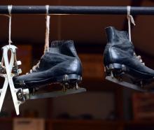 Ice skates hang from the ceiling.