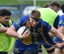 Otago lock Fabian Holland charges ahead with ball as A-One Lolofie (left) and Ben Lopas play the...