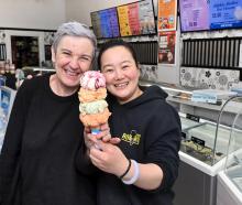Former Rob Roy Dairy owner Liz Watson hands the baton (also known as an ice cream) to new owner...