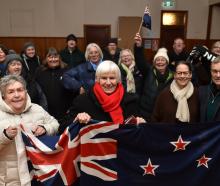 Val Butcher (centre) and a group of Ophir residents cheering on Finn Butcher earlier in his...