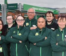 First Union representative Angus Wilson (far right) stands with staff members outside Woolworths...