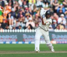 New Zealand’s Rachin Ravindra dispatches a drive on day three of the first test against Australia...