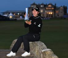 Lydia Ko poses with the Women's Open trophy on the Swilcan Bridge at St Andrews Old Course in...