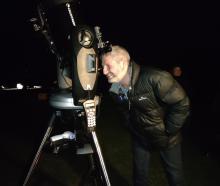 Kaikōura Mayor Craig Mackle looks at the moon through a telescope for the first time. Photo:...