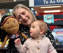 Mosgiel Library librarian assistant Kerri Hayes holds 9-month-old Lyra Parata-Mercer and a Māori...