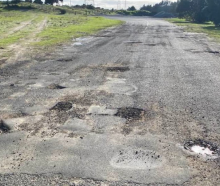 Potholes blight New Zealand's local roads, such as this one in Northland. Photo: Facebook...