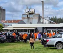 Workers heading into a Winstone Pulp International meeting after news of the closure of two of...