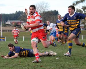Tyler Bichan takes in the surroundings as he breaks away from Jared Hayes (ground) and Damon...