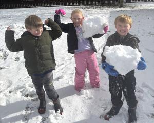 Gus Nichol (6) Florence Harris (7) Jack Richards (6) enjoy the snow at Lee Stream School. Photo:...