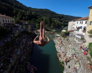 A man jumps from a 17m bridge during a diving exhibition, in Kanal, Slovenia. PHOTOS: REUTERS