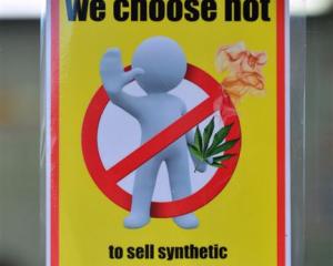 A shop displays a sign indicating it does not sell synthetic cannabis products. Photo by Peter...
