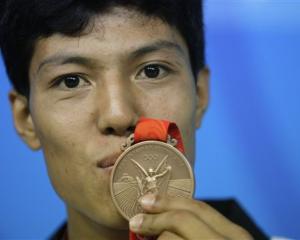 Afghanistan's Rohullah Nikpai attends a press conference with his bronze medal awarded n the men...
