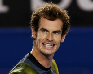 Andy Murray of Britain reacts during his men's singles semi-final match against Roger Federer of...