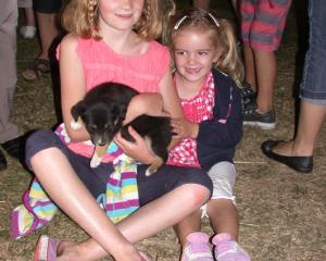 Chloe (8) and Abby (3) Wilson with an 8 week old huntaway pup.