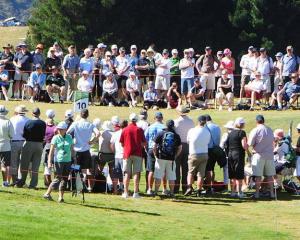 Crowds gather to watch the leaders at the New Zealand Open at The Hills course in Arrowtown today...