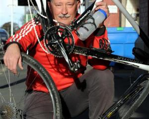 Cyclist Pascal Sutherland holds his bike, which was damaged when a motorist ran over it on...